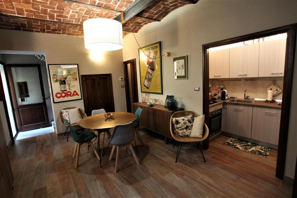 a kitchen and dining room with a table and chairs at La casa dell' artista in Turin