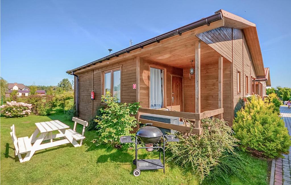 a small house with a grill and a picnic table at Beautiful Home In Wicie With Kitchen in Wicie