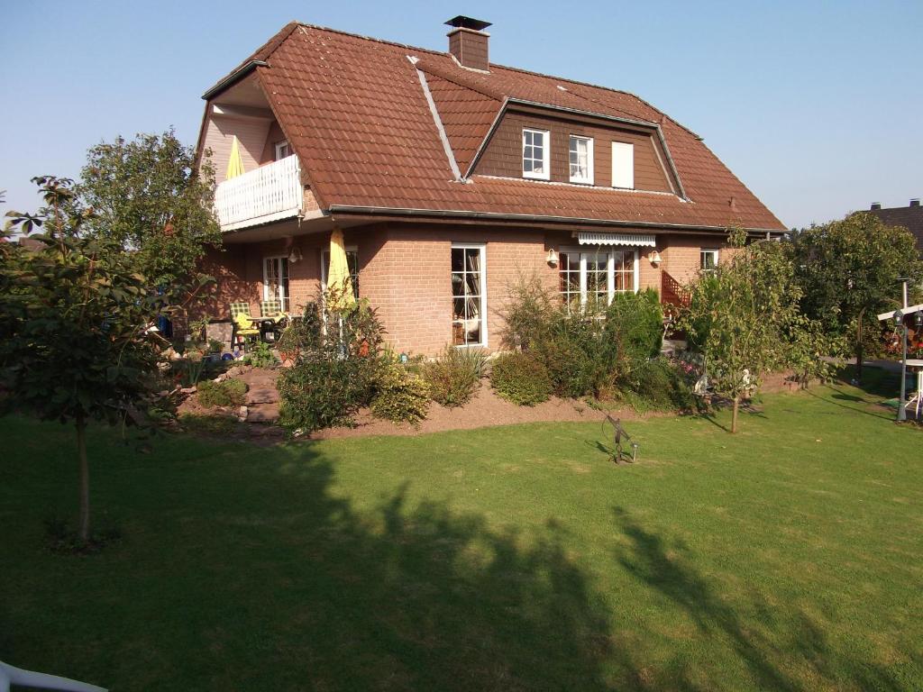 a house with a large yard with a grassy yard at Haus Alexandra in Bad Driburg