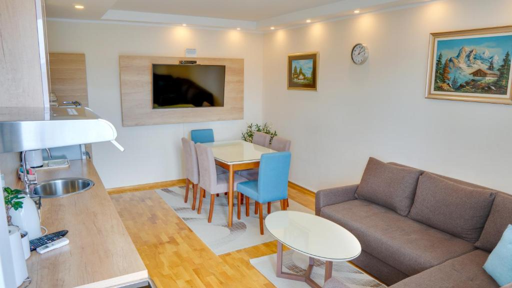 een woonkamer met een bank en een tafel bij MILICA 65m2, Free parking & Wi-fi in Novi Sad