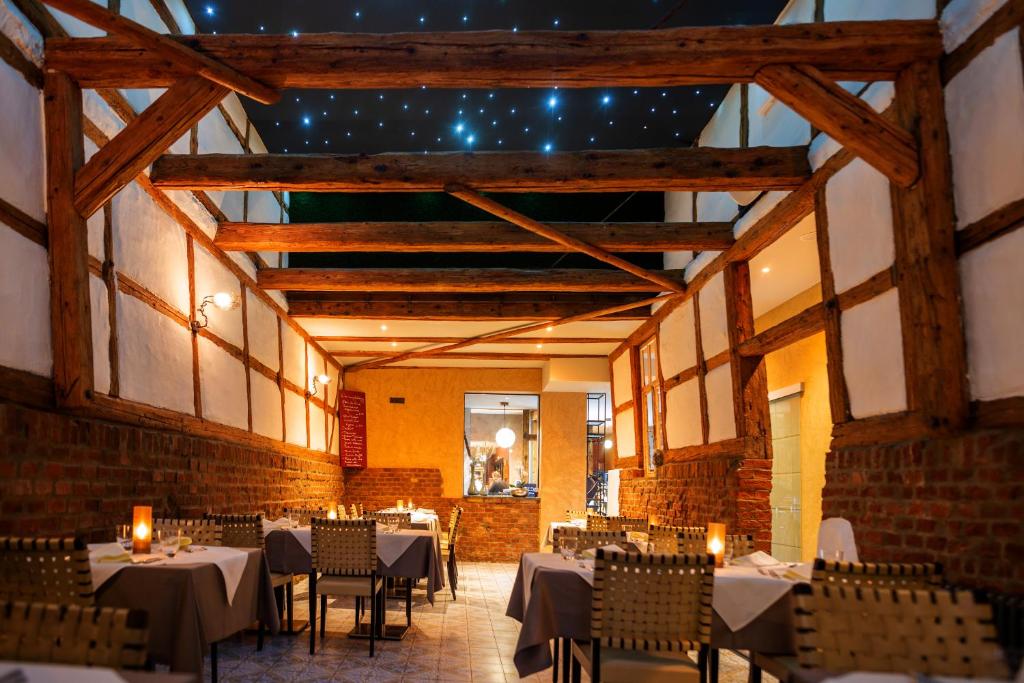 un comedor con mesas y sillas con luces en Trattoria & Apartments - Casa da Enzo, en Goslar