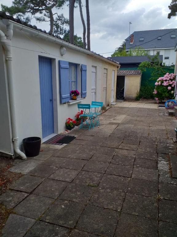 un patio avec deux chaises et un bâtiment dans l'établissement L'îlot à la Baule Homey Home's, à La Baule