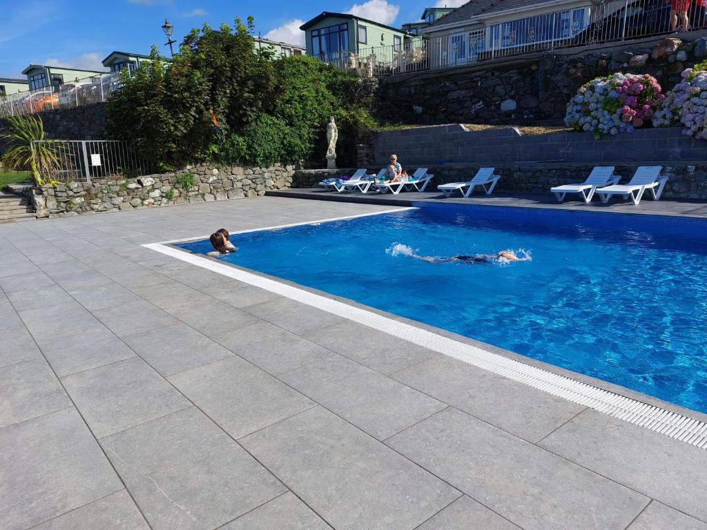 a person swimming in a swimming pool at Hendre Coed Isaf Caravan Park in Barmouth