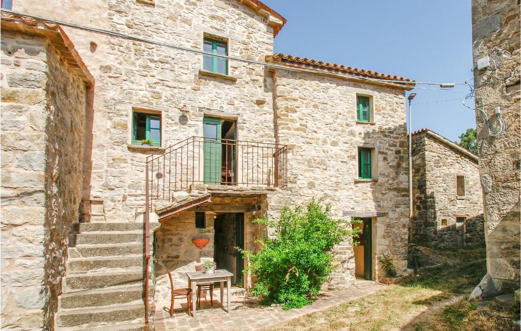 una casa in pietra con scale e tavolo di Lovely Apartment In Villagrande Di Monteco With House A Panoramic View 