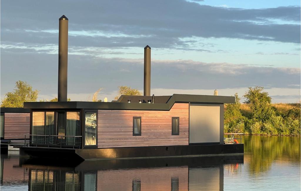 a house on a dock on a body of water at Statendam 12 Oh Laak in Ohé en Laak