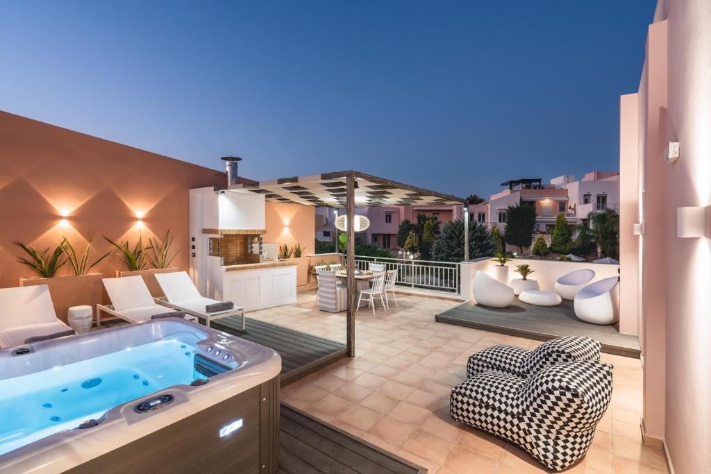 a backyard with a hot tub and a patio at Afroditi Suite in Loutra