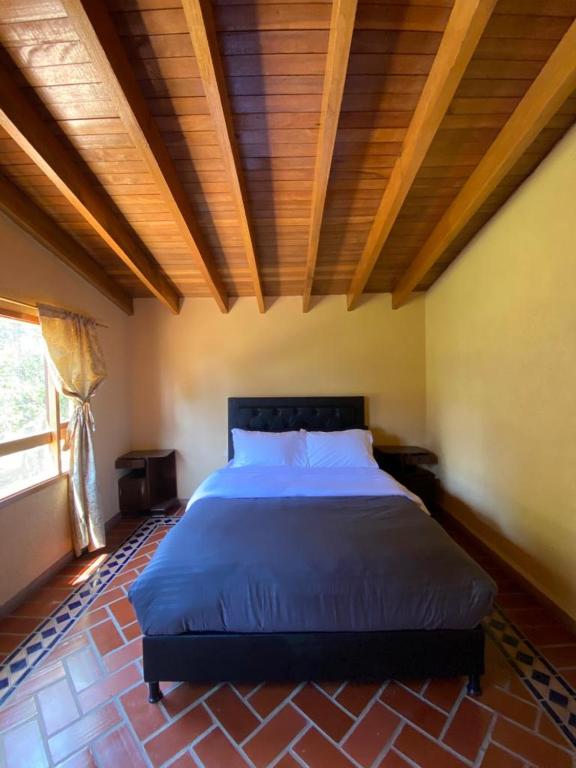Postel nebo postele na pokoji v ubytování CASA CAMPESTRE Cucunuba