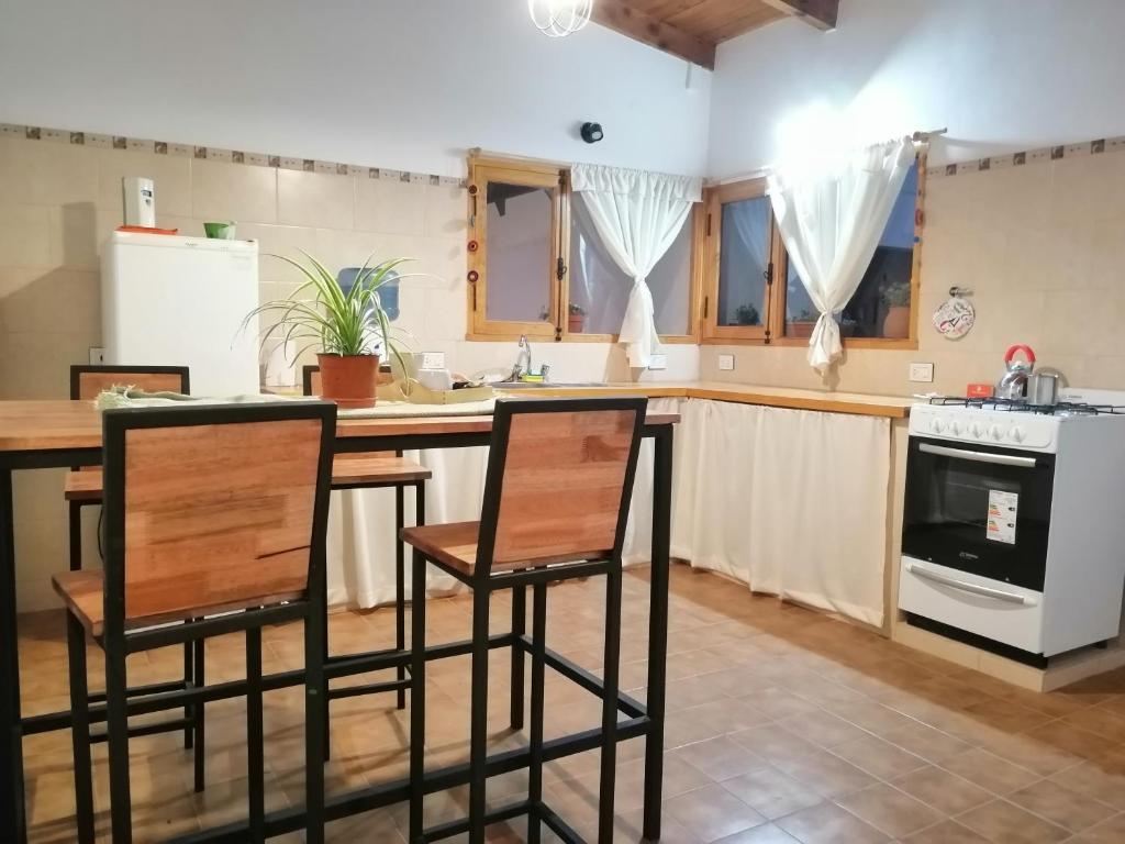 a kitchen with a table and two chairs in it at Departamento Los Inmigrantes in Esquel