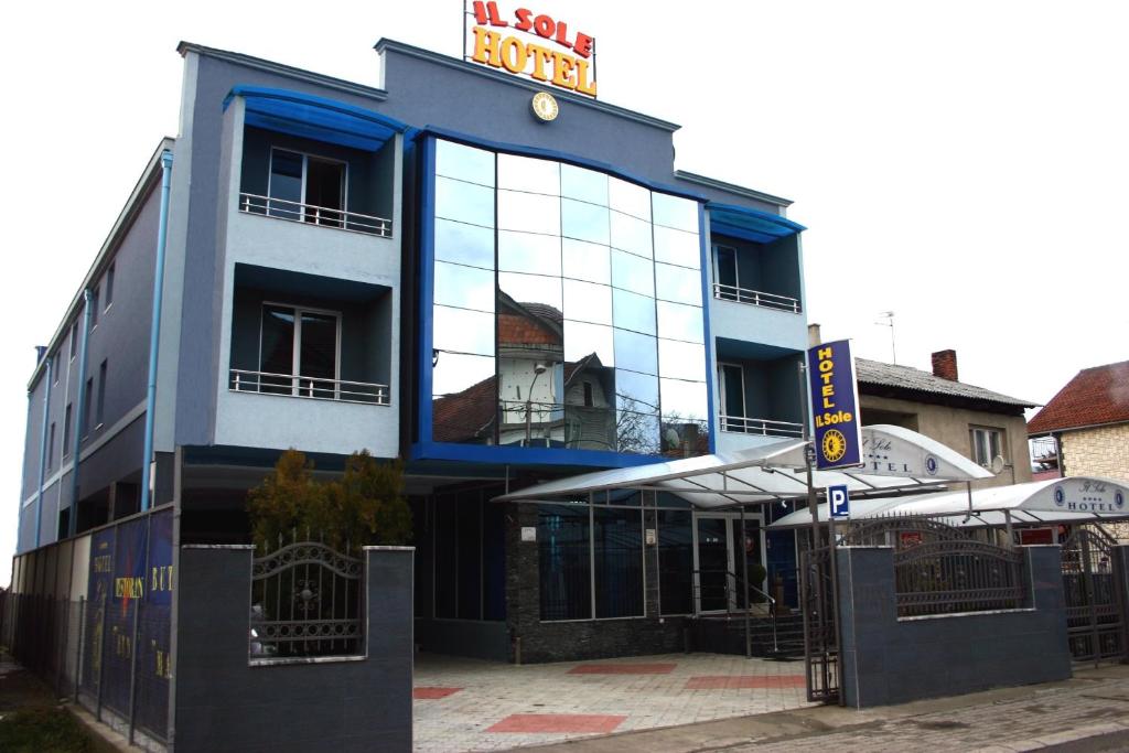 a building with a large window on the side of it at Hotel IL Sole in Berane