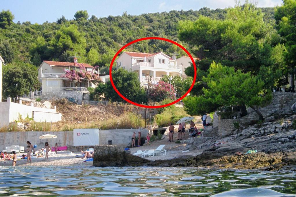 a house on the shore of a body of water at Apartments by the sea Postira, Brac - 5152 in Postira