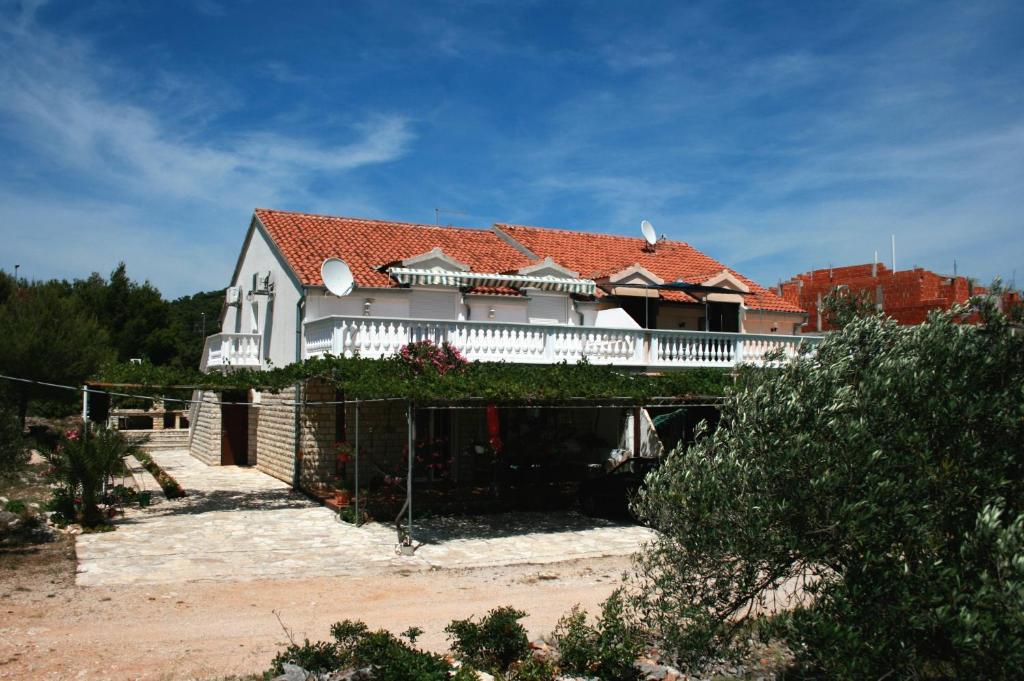 ein großes weißes Haus mit einem roten Dach in der Unterkunft Apartments and rooms with parking space Jezera, Murter - 5082 in Jezera