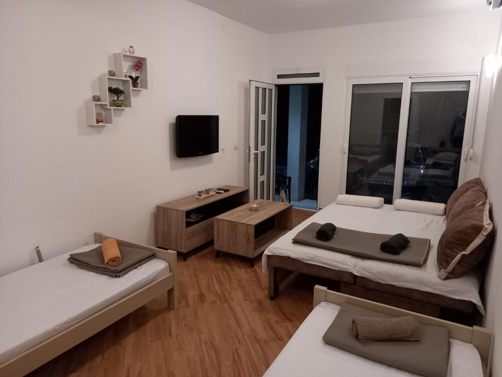 a living room with two beds and a tv at Apartman Susanj Bar in Bar