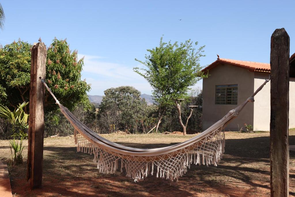 a hammock in front of a house at Chalés Excalibur in São Thomé das Letras