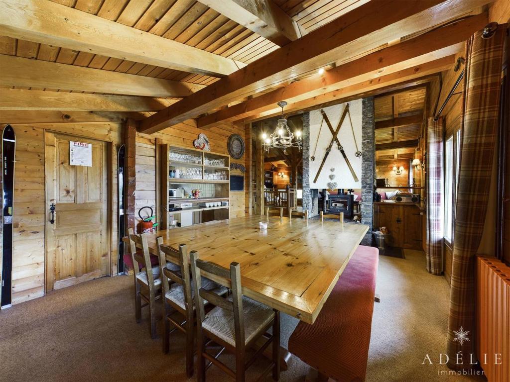 a dining room with a large wooden table and chairs at Chalet Montvalezan-La Rosière, 9 pièces, 14 personnes - FR-1-398-647 in Montvalezan
