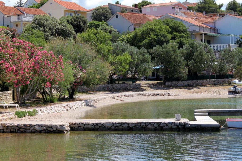 a small island in a body of water with houses at Apartments with a parking space Grebastica, Sibenik - 13365 in Bašelovići