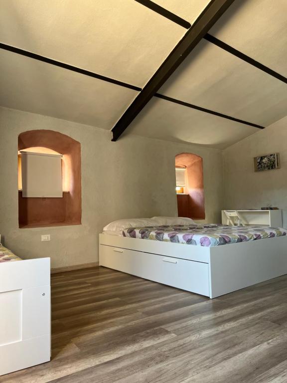 a bedroom with a large bed and two mirrors at B&B tre fiori in Taranta Peligna