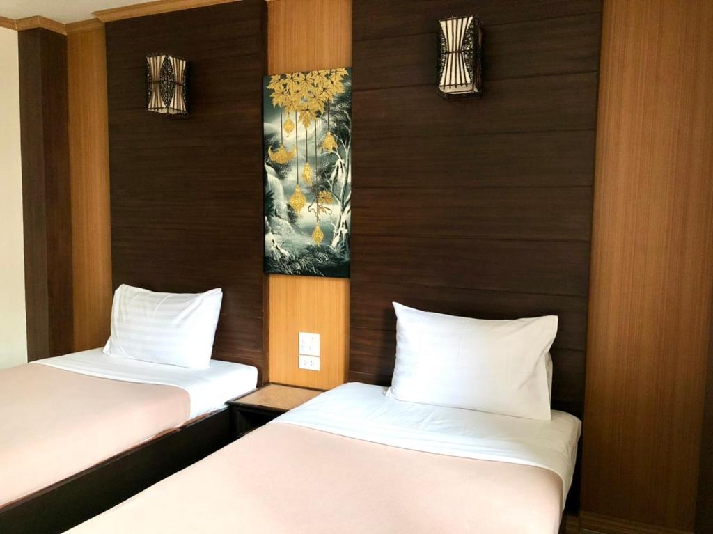 Postel nebo postele na pokoji v ubytování Visanuinn Hotel
