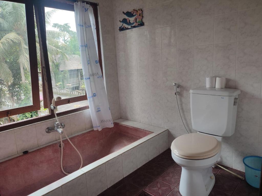 Koupelna v ubytování Sari Wangi Cottage