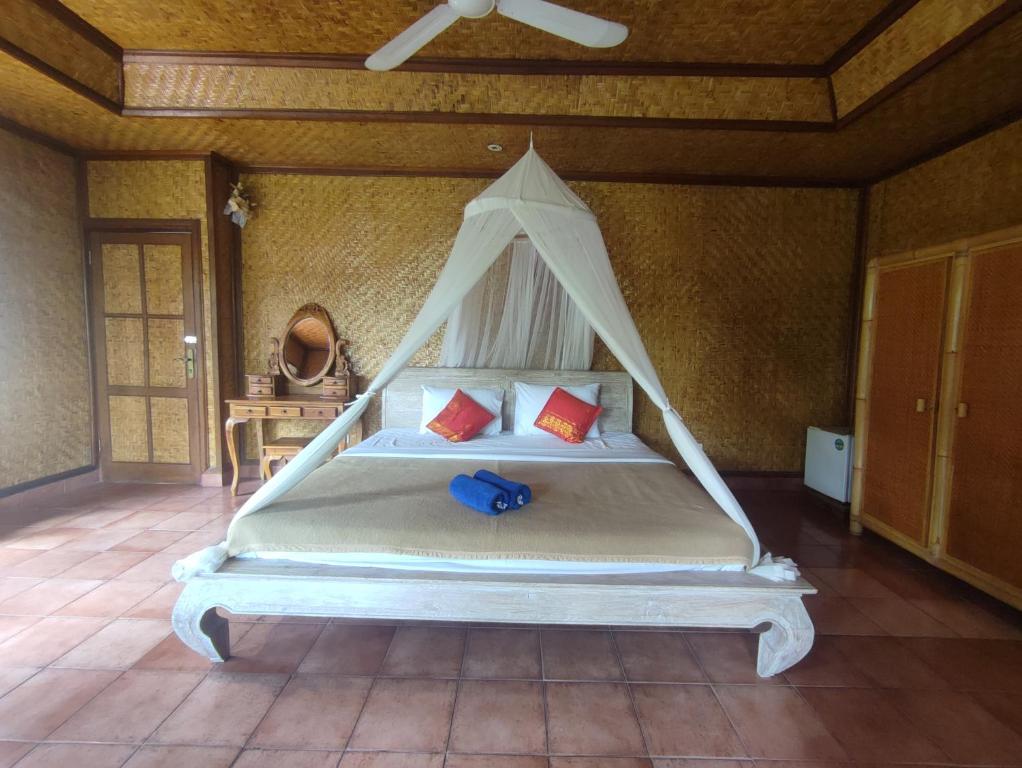 Postel nebo postele na pokoji v ubytování Sari Wangi Cottage