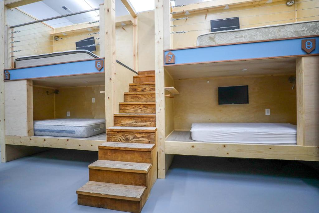 two bunk beds in a room with a staircase at Podshare San Francisco Marina in San Francisco