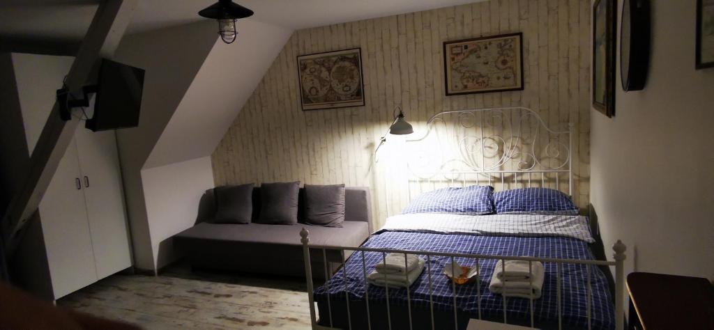 a bedroom with a bed and a couch at Seaside in Gdańsk