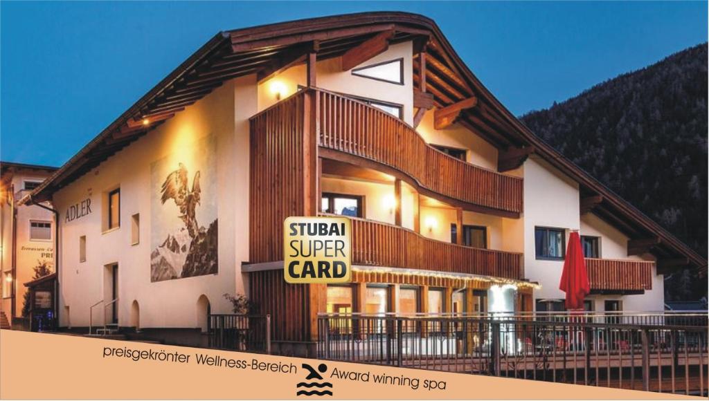 a building with a sign that reads spinal super card at Adler Hotel-Pension in Fulpmes