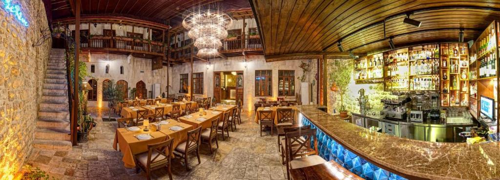 a restaurant with tables and chairs and a bar at Le Reve Butik Otel in Hatay