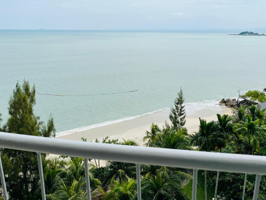 a view of the beach from the balcony at Paradise by the Sea in Penang by Veron at Rainbow Paradise in Tanjung Bungah