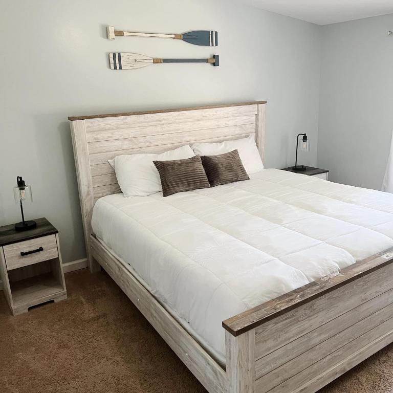 a bedroom with a large white bed with two night stands at Homie Sweetie in Morong