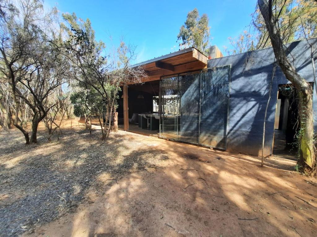 a house in the middle of a desert with trees at Vulture's View 6 in Hartbeespoort