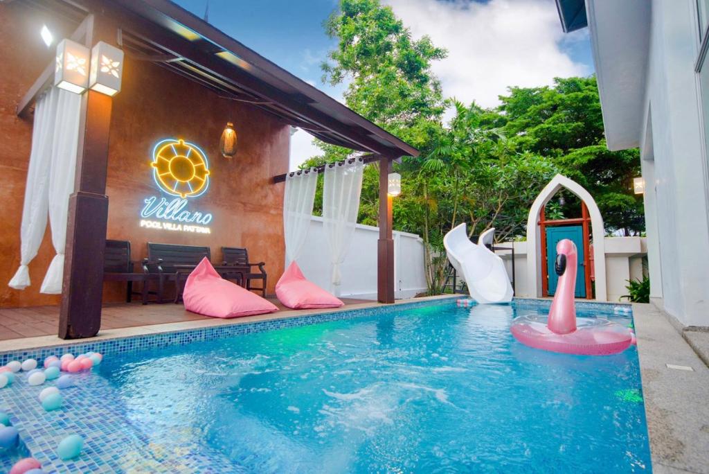 a swimming pool with a inflatable swan in a backyard at Twenty Two Pool Villa in Pattaya
