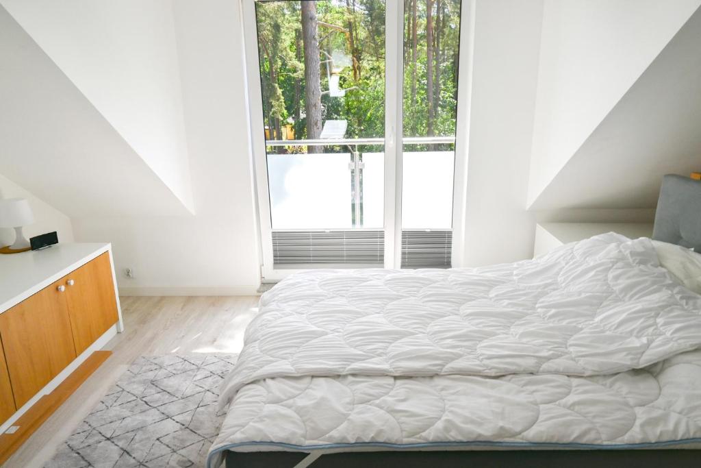 Łóżko lub łóżka w pokoju w obiekcie Komfortowy apartament dwupoziomowy w cichej okolicy