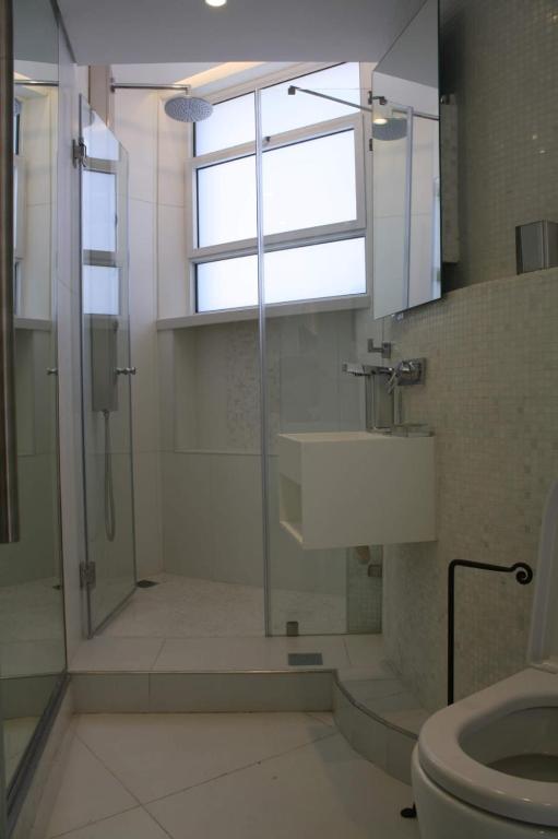 a bathroom with a shower and a toilet and a window at The White House Jerusalem סוויטת הבית הלבן ירושלים in Jerusalem