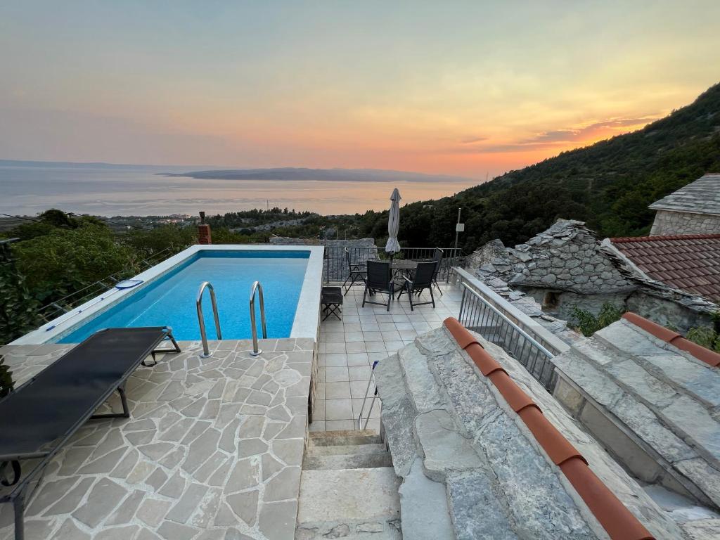 a villa with a swimming pool and a patio at Villa Kristina - Ferienhaus Baška Voda - Topići, Private Outdoor Swimmingpool, WiFi in Baška Voda