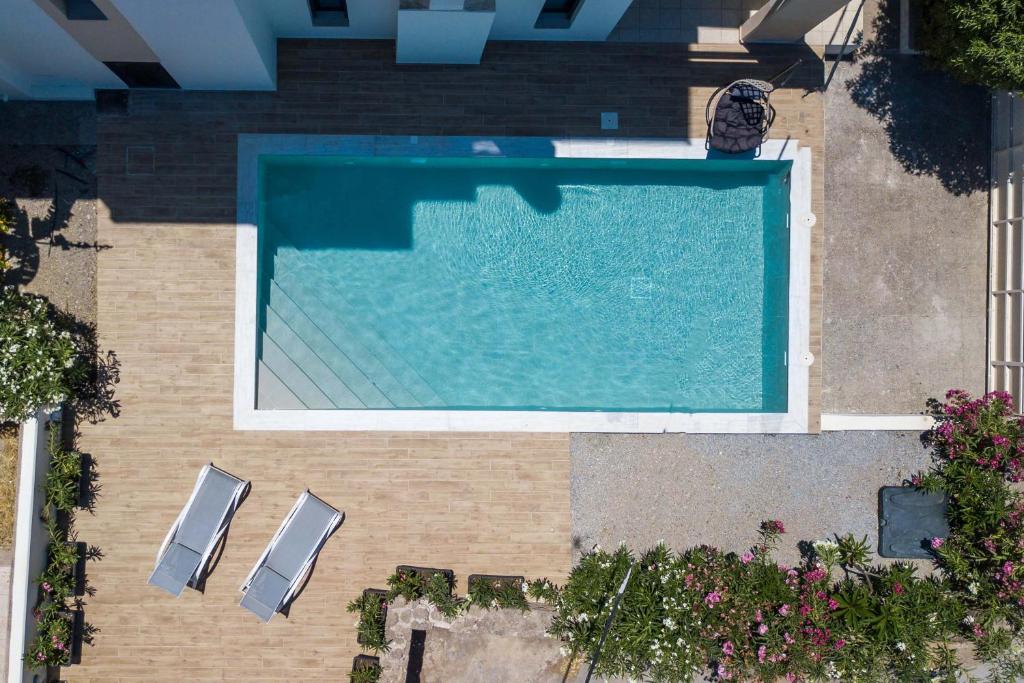 an overhead view of a swimming pool with two chairs at Villa Laila in Ialyssos