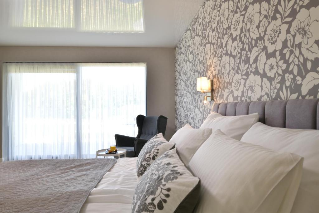 Una cama o camas en una habitación de TI Hotel