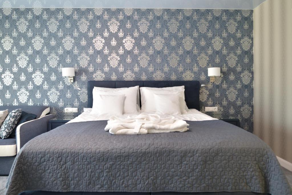 Una cama o camas en una habitación de TI Hotel