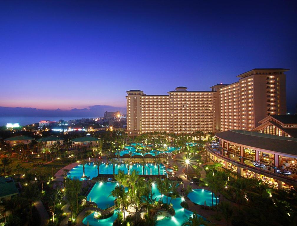 a view of a hotel with pools at night at Howard Johnson Resort Sanya Bay in Sanya