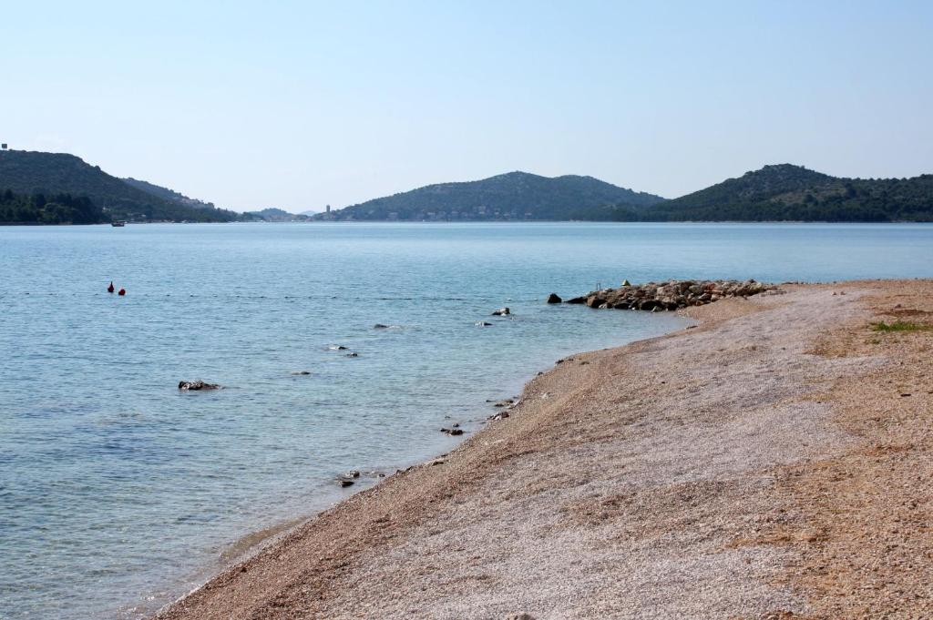 a group of people swimming in a large body of water at Apartments with a parking space Betina, Murter - 17478 in Betina