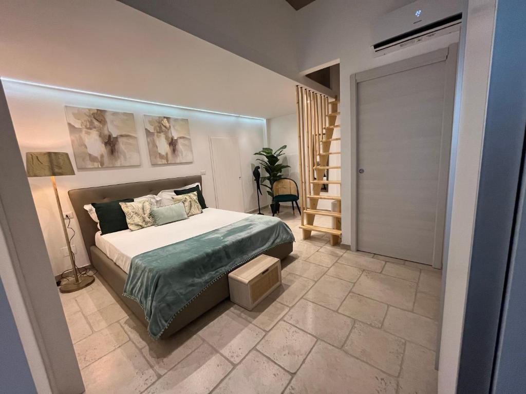 a bedroom with a bed and a door with a staircase at Casa Frida in Vieste
