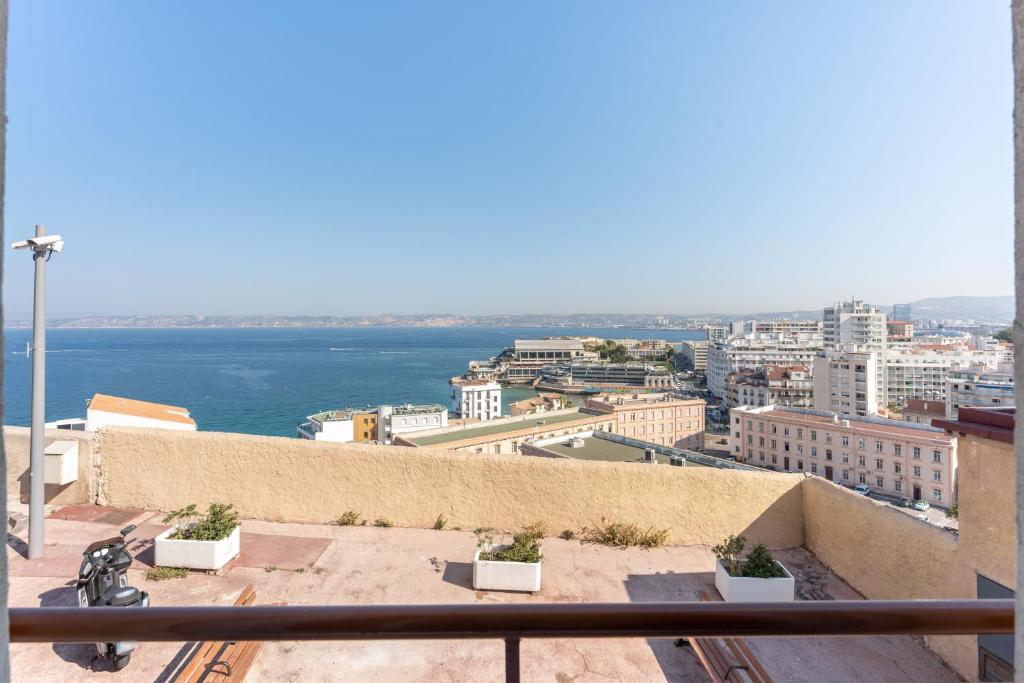 a view of the ocean from a balcony of a building at ROCCA BIANCA - Sur la roche face à la mer et la bonne mère in Marseille