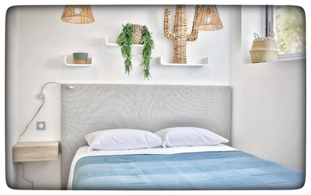 a bedroom with a bed and two potted plants at Le Vallaya Suites & Spa in Menton