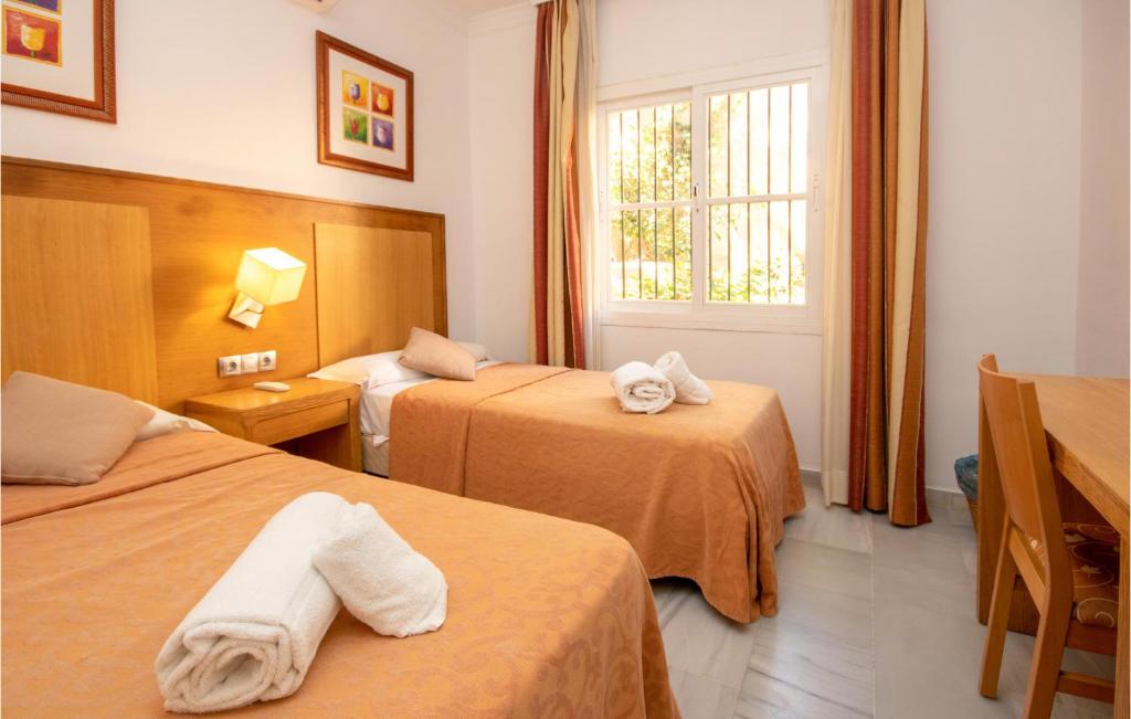 A bed or beds in a room at Nice Apartment In Calahonda With Wifi