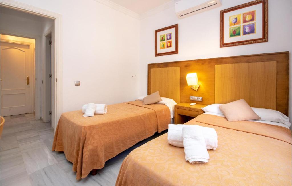 A bed or beds in a room at Nice Apartment In Calahonda With Wifi