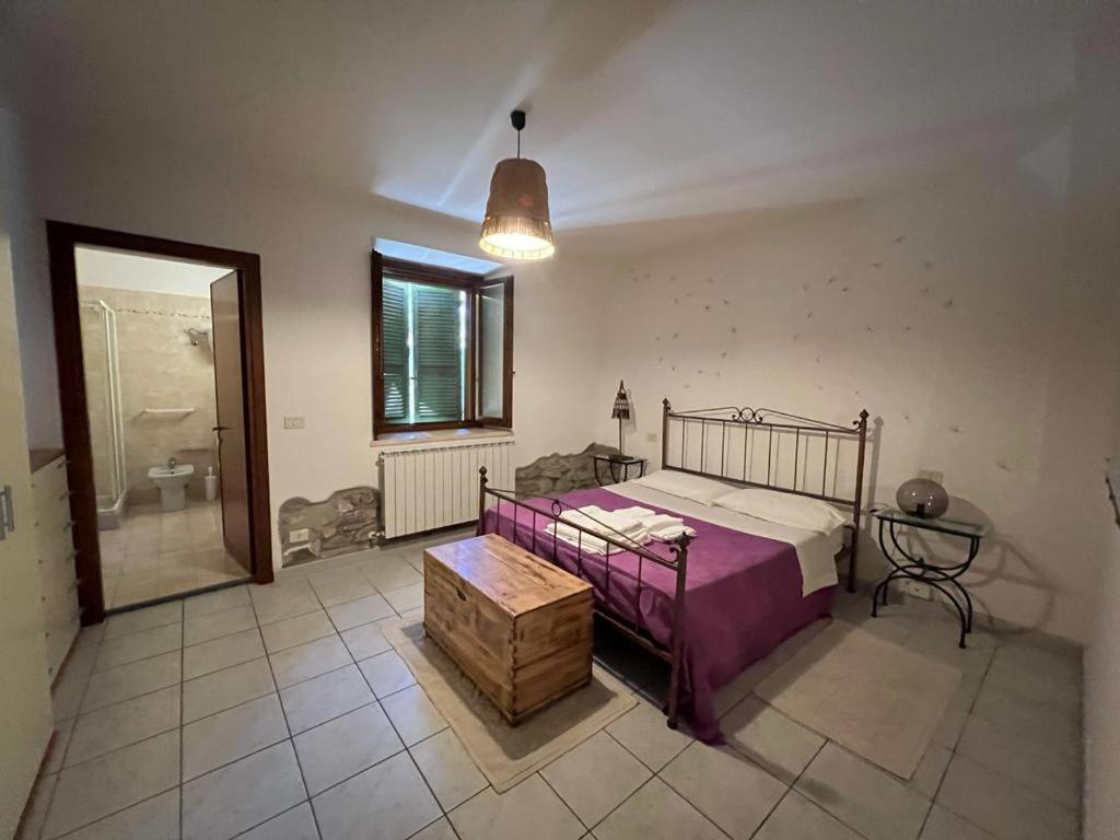 a bedroom with a bed and a bathroom with a shower at La casa di Anna in Torricella