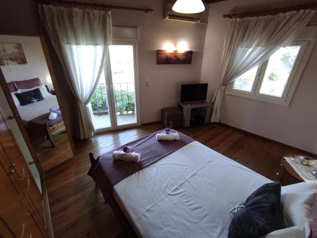 a bedroom with a large bed with two towels on it at LAFION HOUSE in Lafiónas