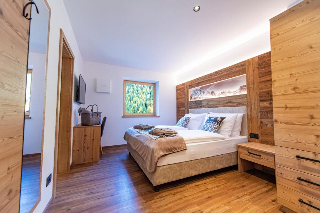 A bed or beds in a room at Luech da Perteut - Panorama and Wellness