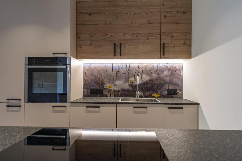 A kitchen or kitchenette at Luech da Perteut - Panorama and Wellness