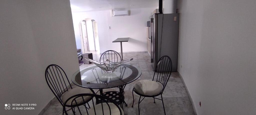 a dining room with a glass table and chairs at AppartGrasseBBQ in Grasse