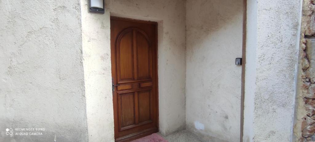 a wooden door in the corner of a building at AppartGrasseBBQ in Grasse